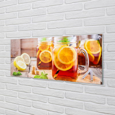 Glas panel Kallt te med sugrör av citrus