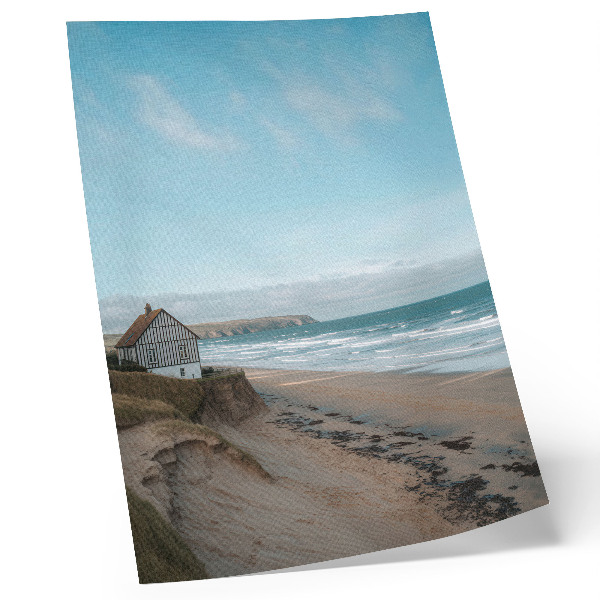 Poster Strand, vågor, hus på en klippa, pastellfärger