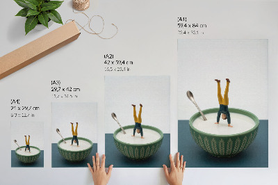 Poster Figur i en skål med mjölk med gröna blad