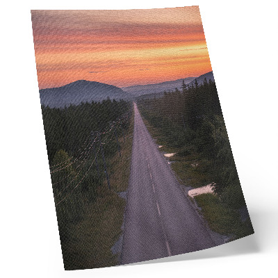 Poster En rak väg genom skogen i en pastellfärgad solnedgång