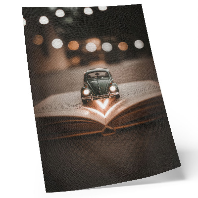 Affisch Miniatyrbil på en bok med magiska ljus