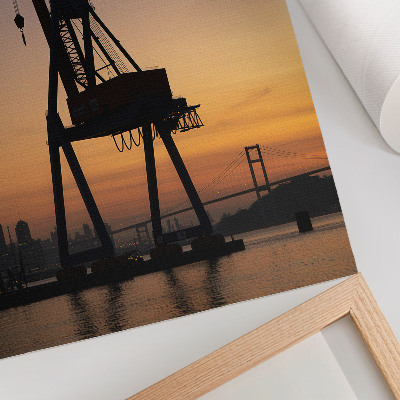 Hållbar väggposter Industriell kran silhuett solnedgång bro