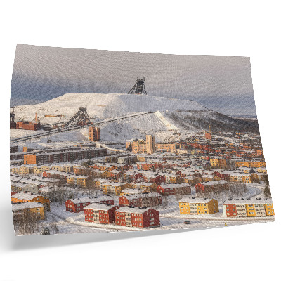 Poster Vinterstad med färgglada byggnader som kontrasterar mot snön