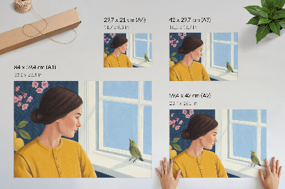 Väggposter Kvinna i en gul skjorta med en fågel på fönsterbrädan