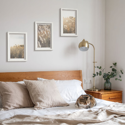 Tavelvägg med 3 tavlor Ett landskap med gräs och blommor i varma nyanser