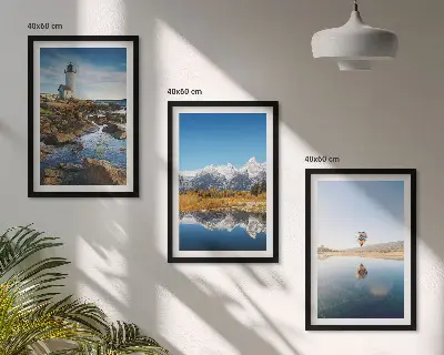 Tavelset ovanför soffan med motiv av natur, fyr, berg och luftballong