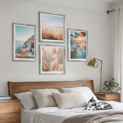 Tavelvägg ovanför soffa Havssolnedgång hus blommor